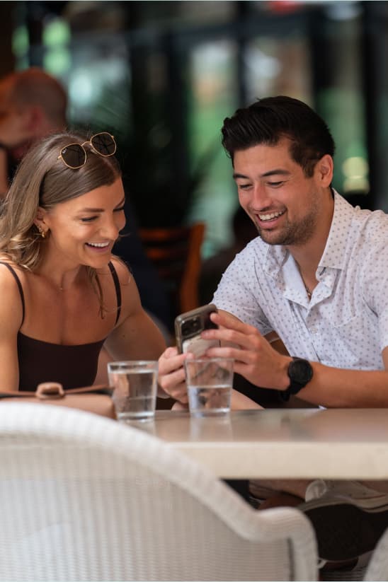 Couple smiling and using app